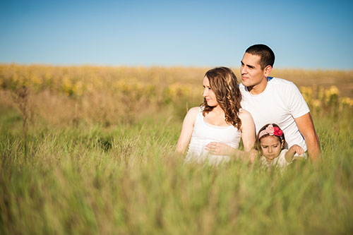 Family in a field of golden grass